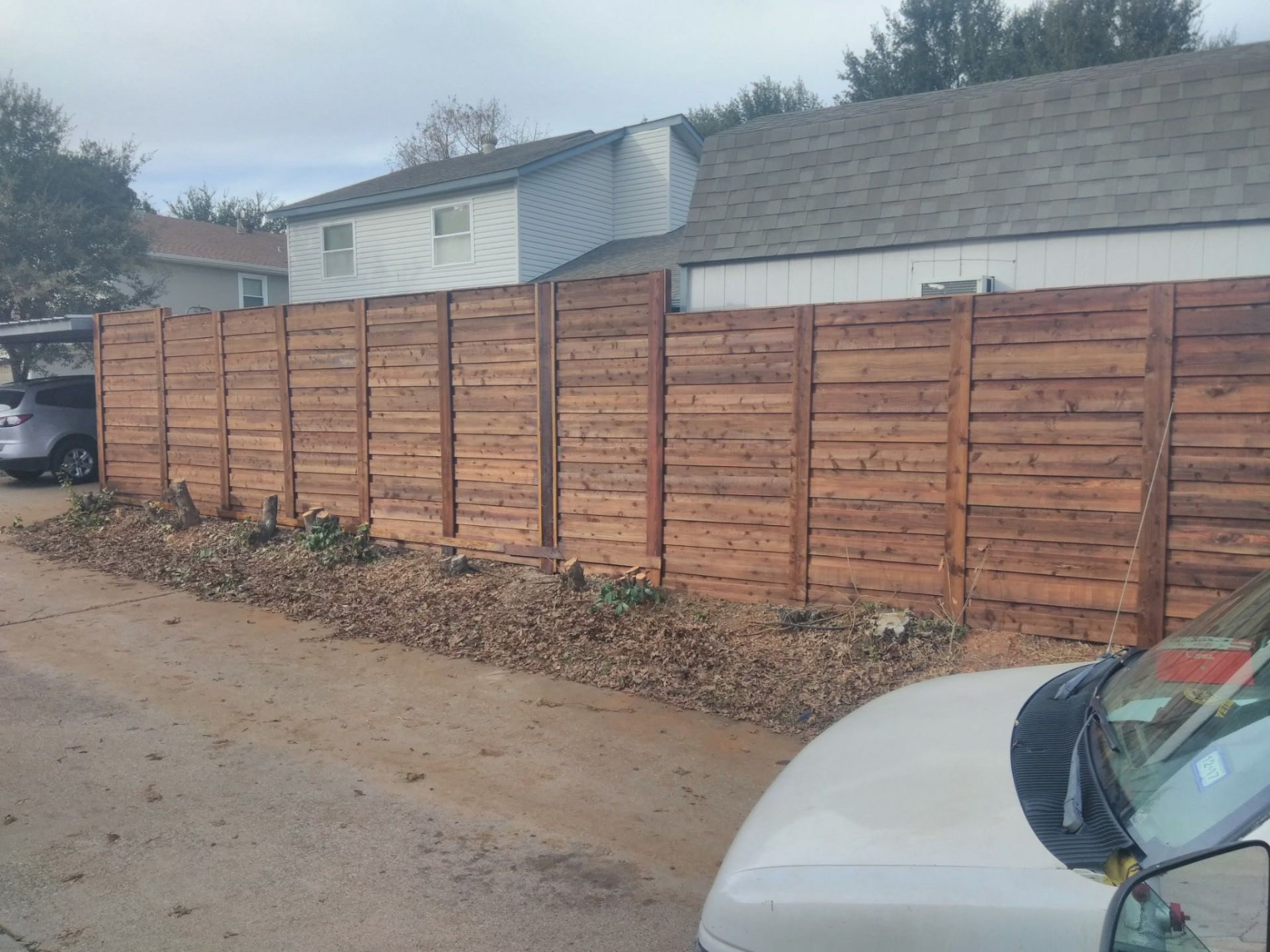 Horizontal cedar privacy fence freshly stained